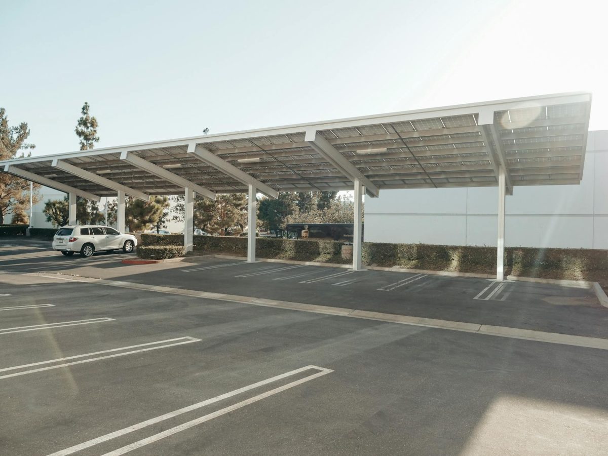 Solar panels installed over a parking lot, showcasing clean energy innovation outdoors.